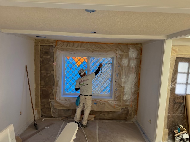 Worker painting in interior residential area