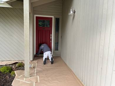 Exterior Painting Job - Worker in Action at Front Door